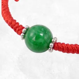 Bracelet tibétain porte-bonheur fil rouge et jade vert béni au Népal