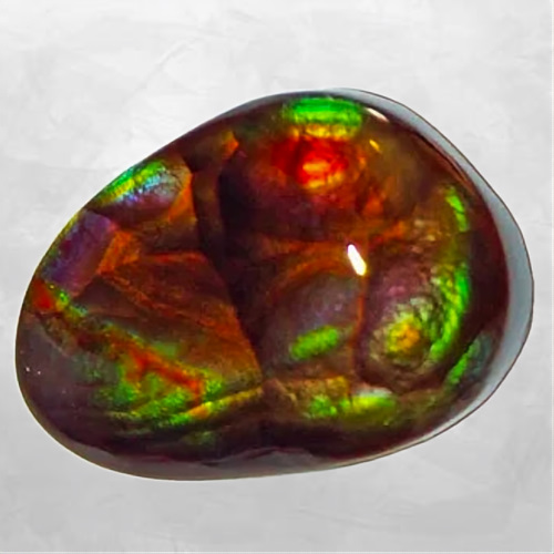 Cabochon d'agate de feu poli, reflets orange et cuivre et vert